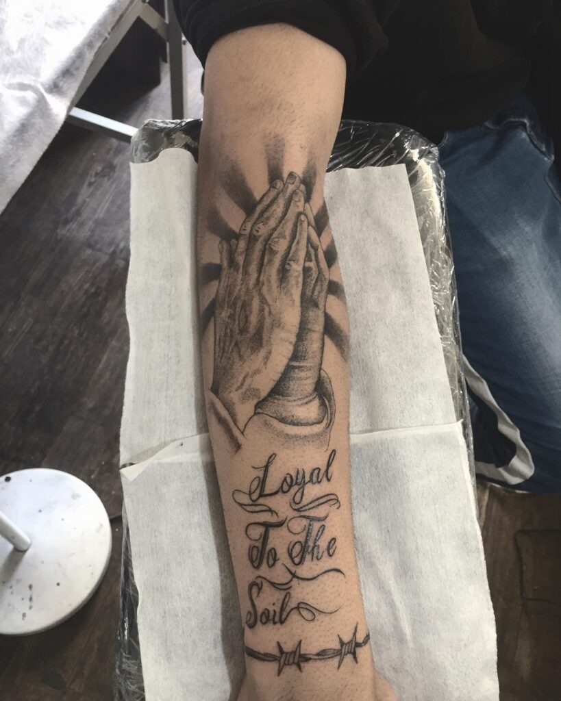 Praying Hands with Rays and Loyalty Script Tattoo Tattoo Design