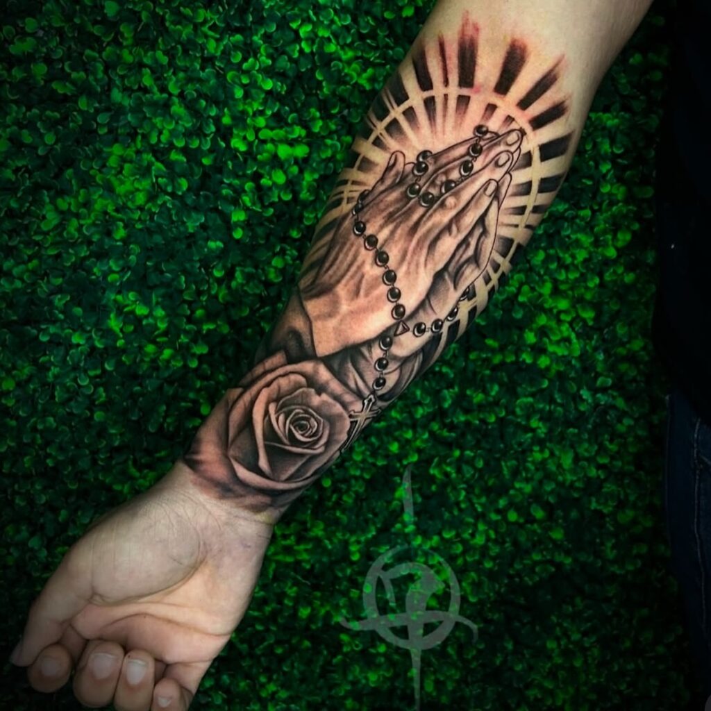 Praying Hands with Rosary, Rose, and Radiant Halo Tattoo Tattoo Design
