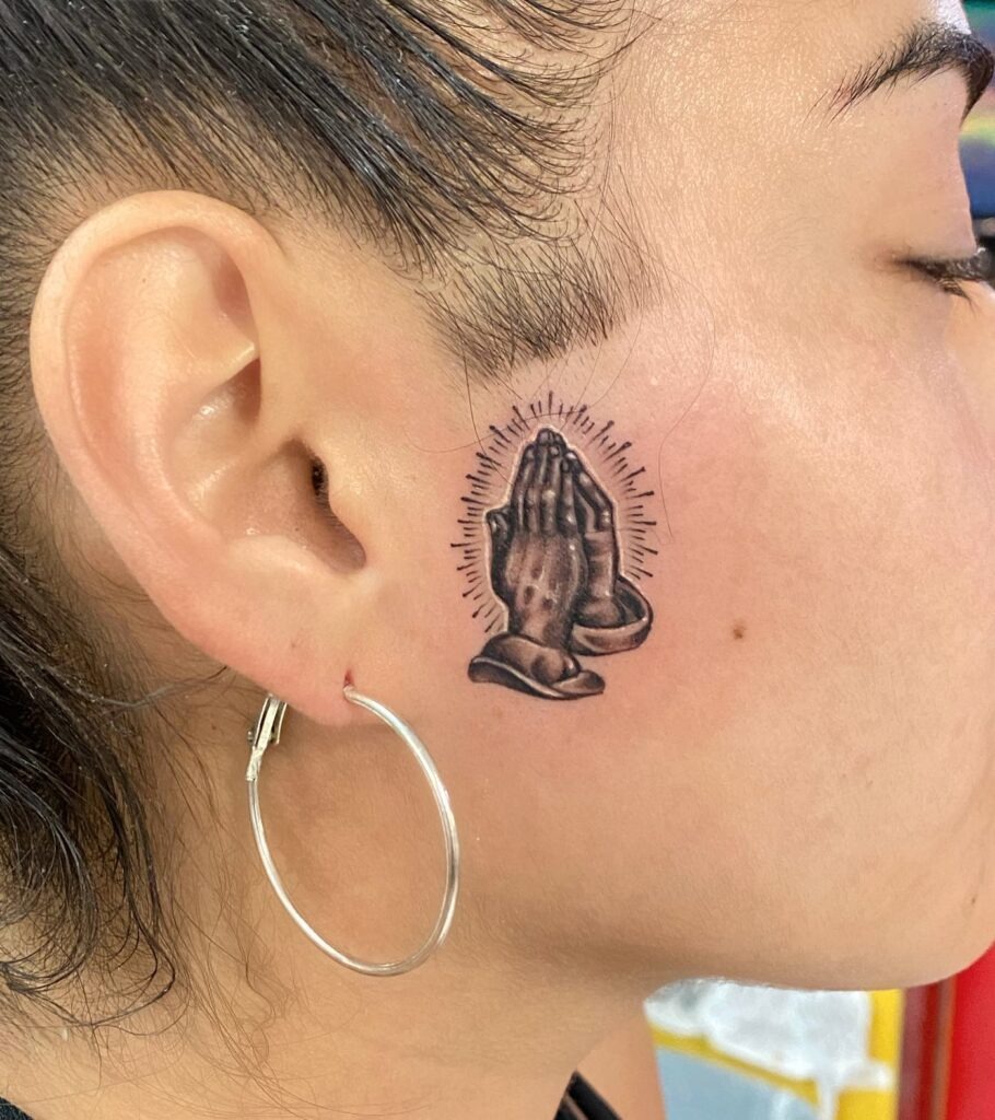 Radiant Praying Hands Face Tattoo Tattoo Design