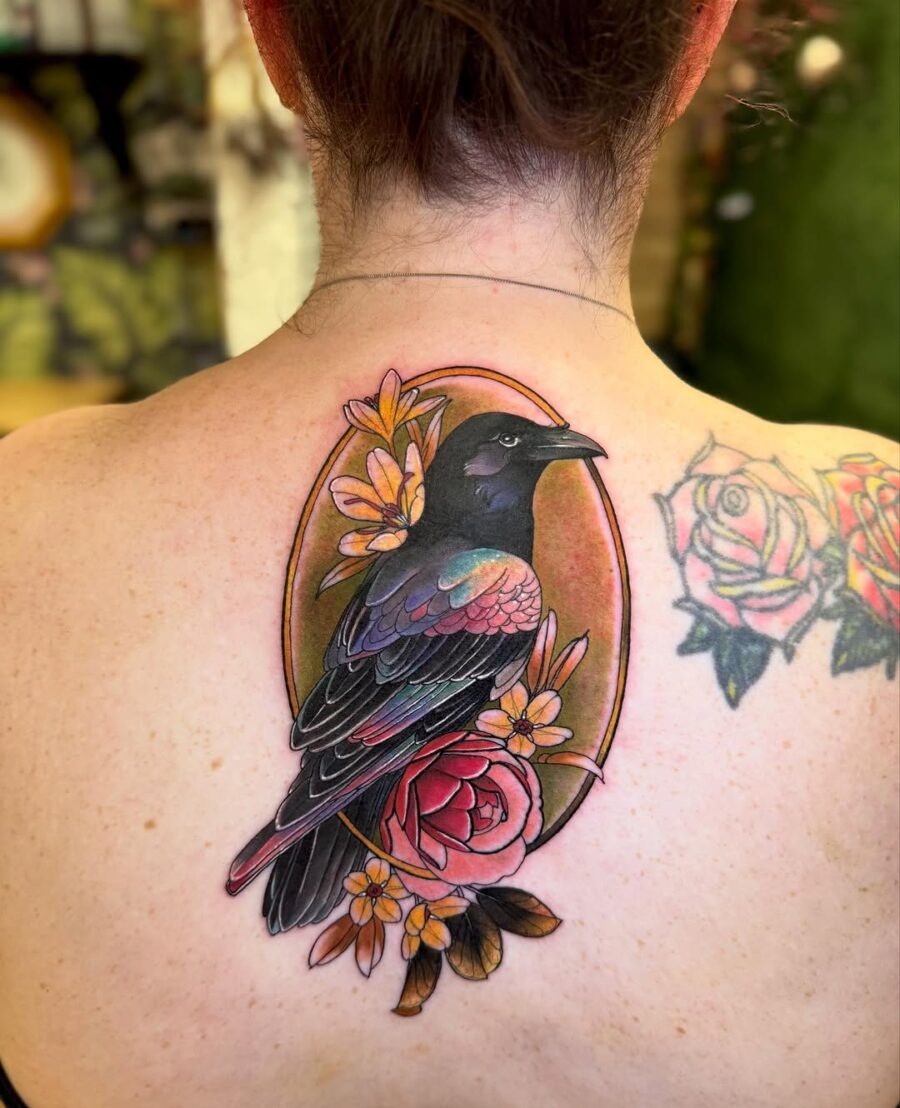 A striking raven tattoo adorned with flowers Tattoo Design