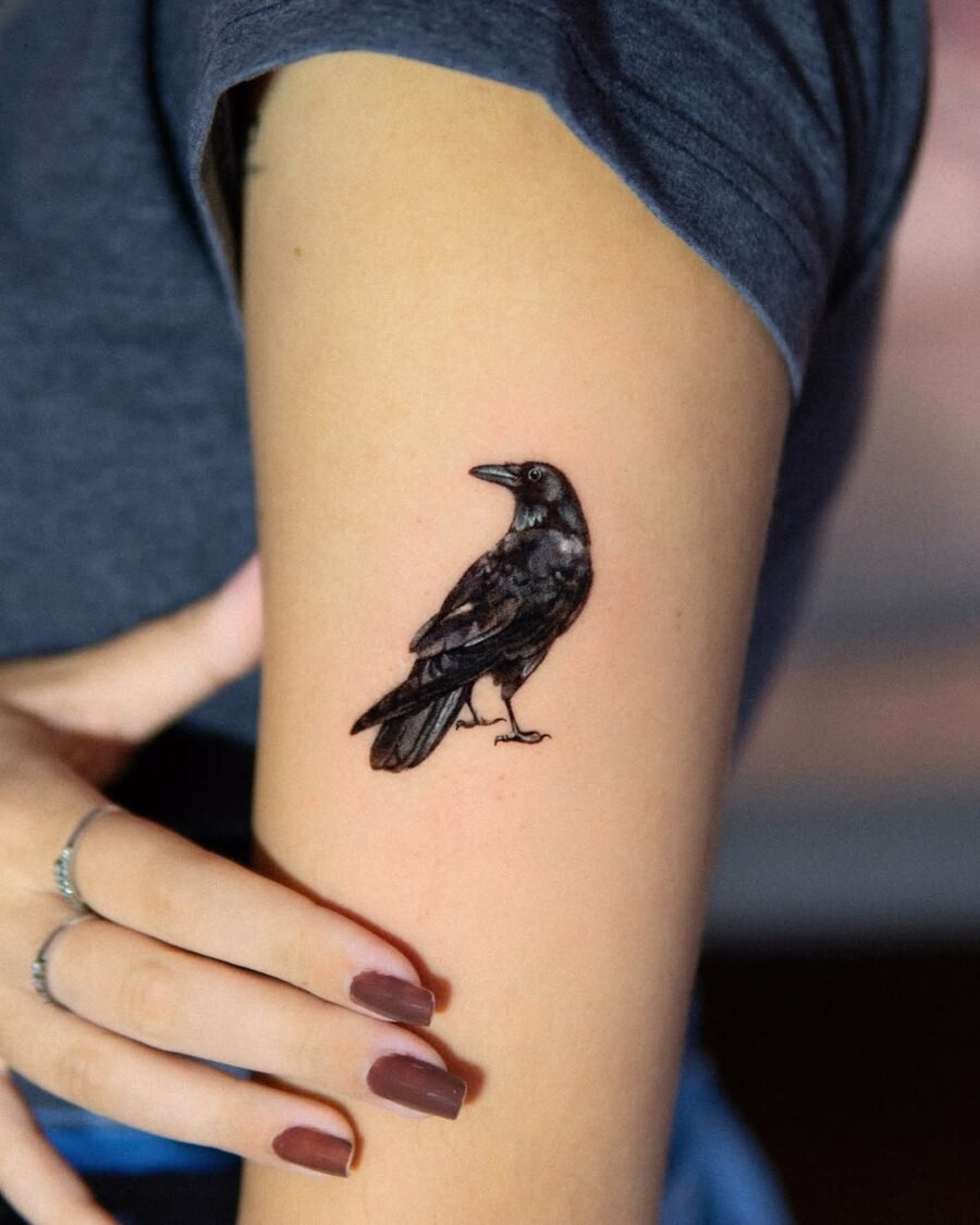 Elegant raven tattoo in striking black ink Tattoo Design