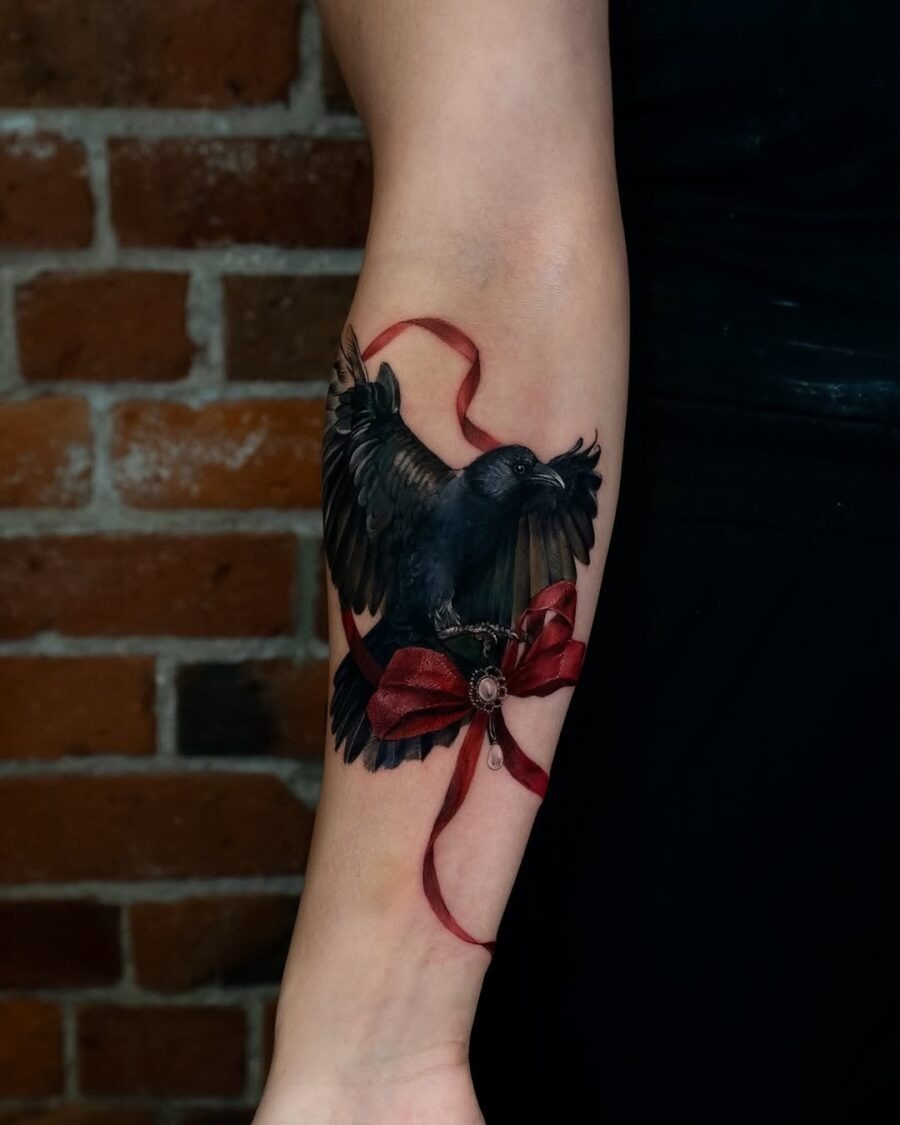 Elegant raven tattoo with striking red ribbon Tattoo Design