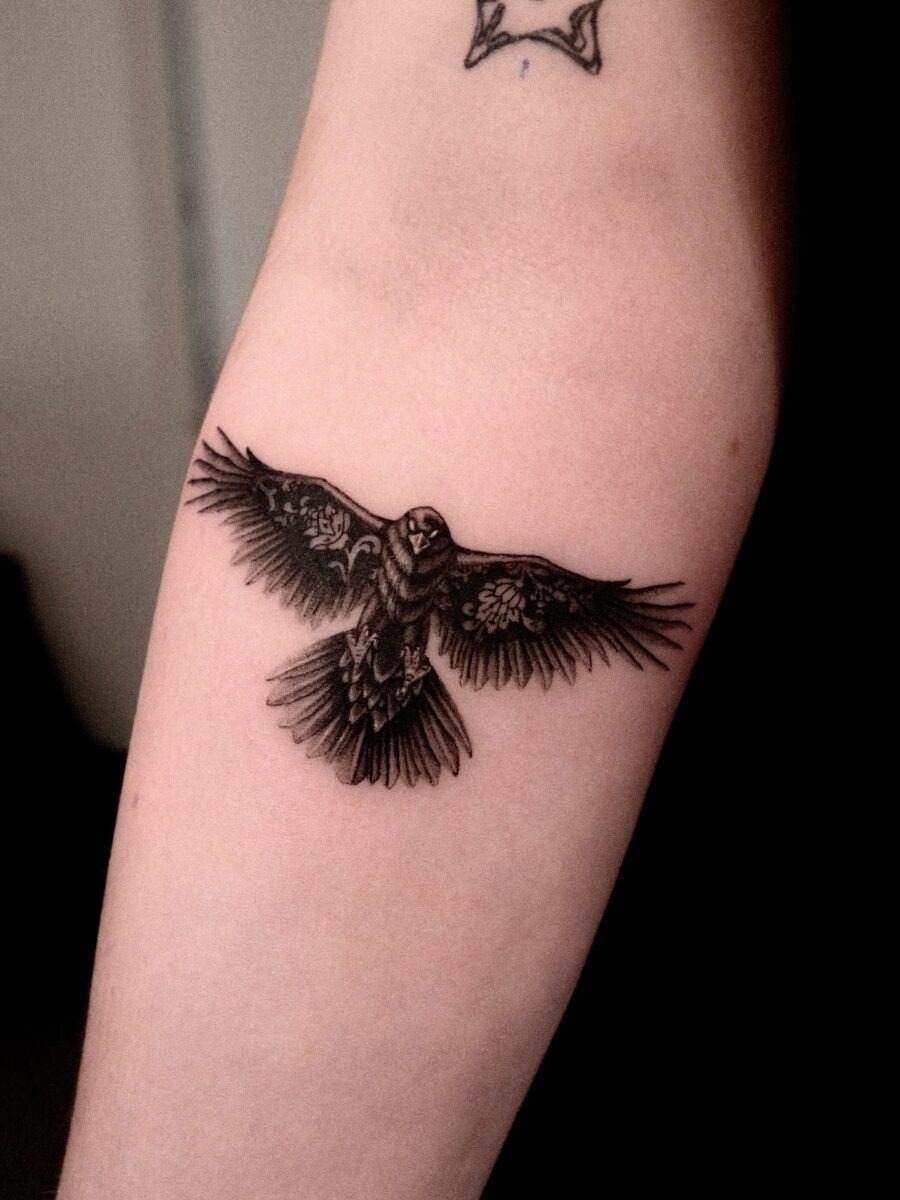 Intricate raven tattoo with detailed feather design Tattoo Design