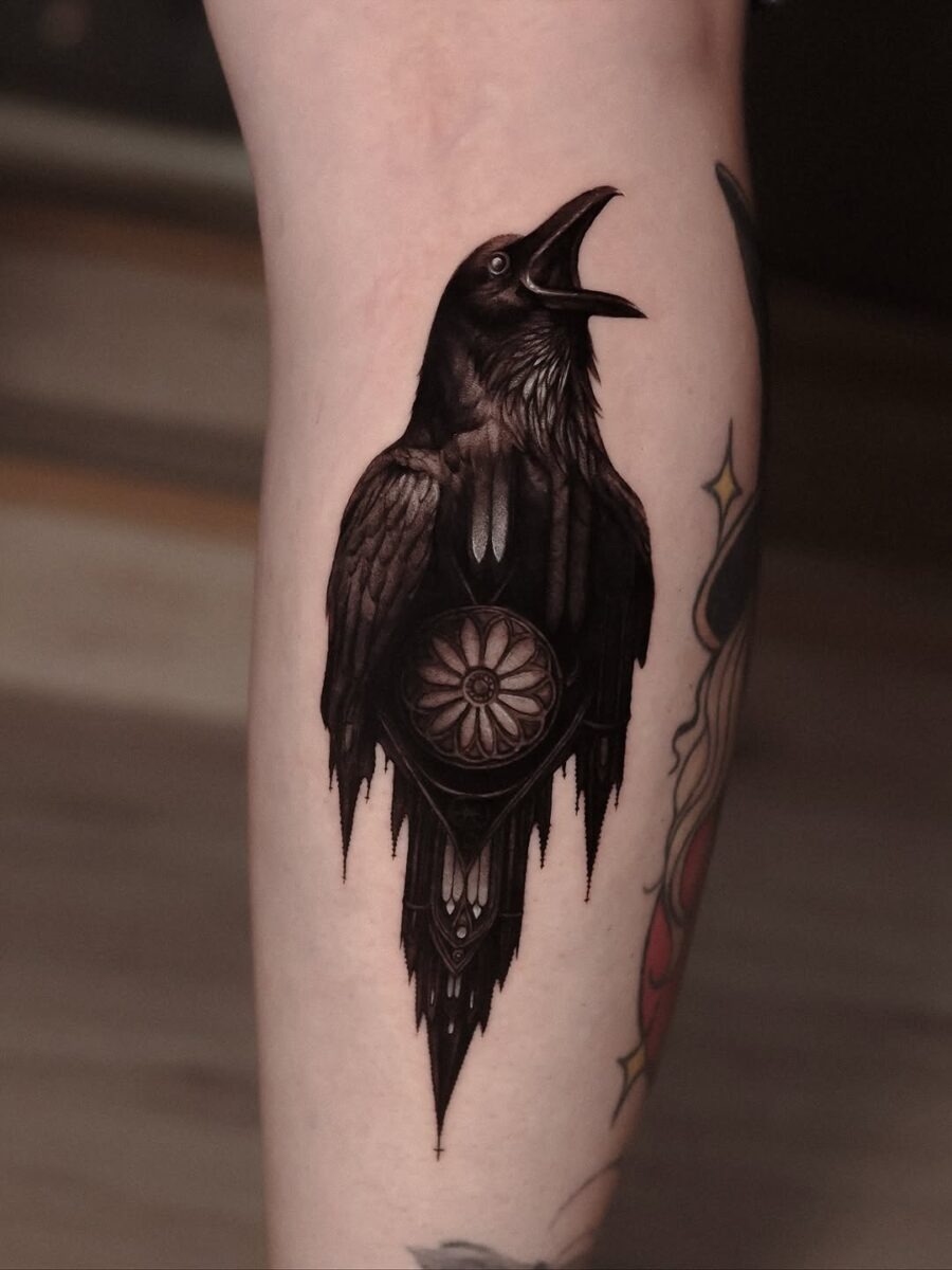 Intricately designed raven tattoo with floral elements Tattoo Design