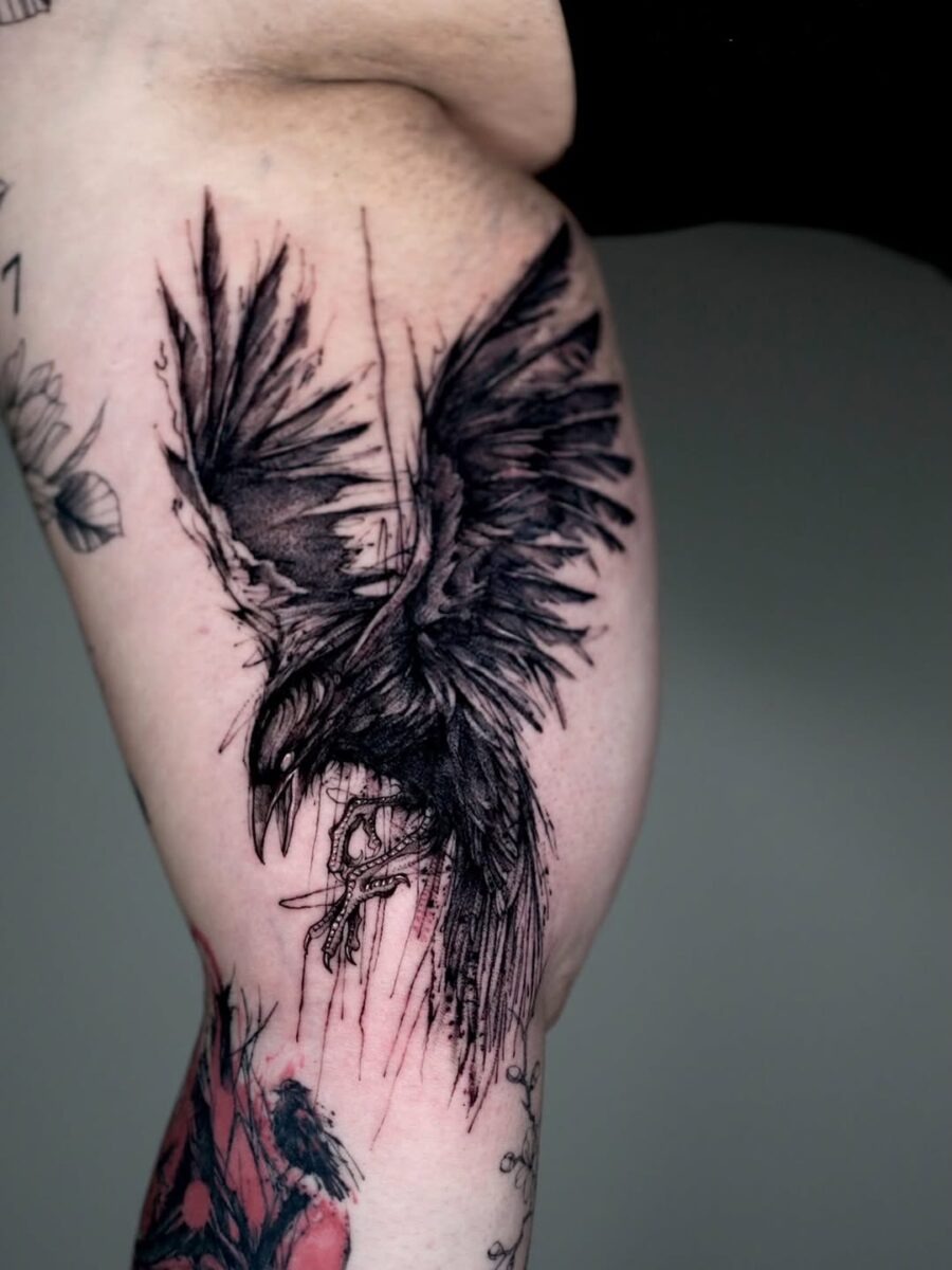 Striking black ink raven tattoo on thigh Tattoo Design