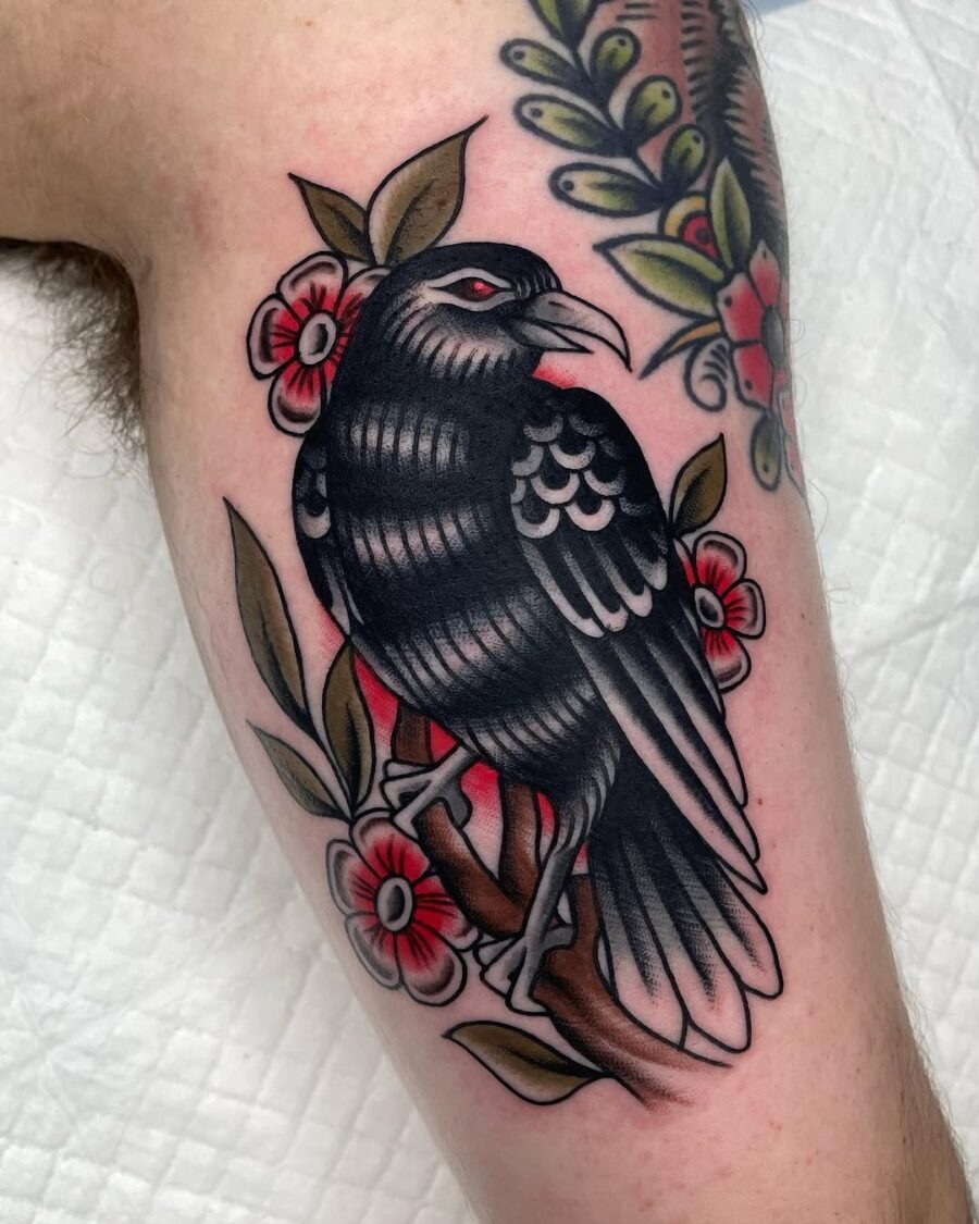 Striking raven tattoo with floral accents Tattoo Design