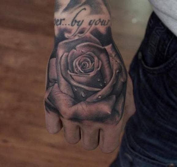 Detailed Uni-colored Rose Tattoo On A Guys Fist Tattoo Design