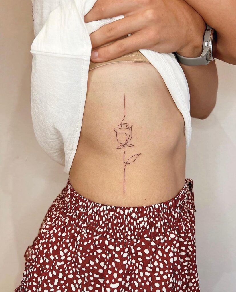 Minimalist One-Line Rose Tattoo on Rib Tattoo Design