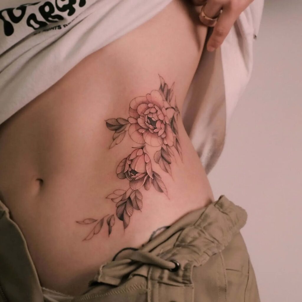 Soft Rose Tattoo on Ribcage Tattoo Design