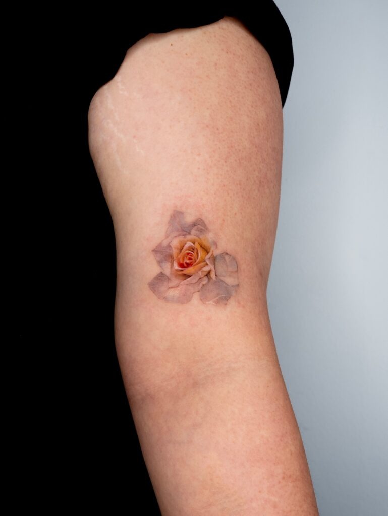 Subtle Fading Rose Tattoo on Arm Tattoo Design