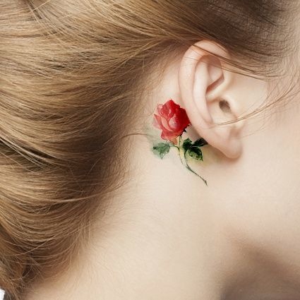 Tiny Bright Colored Rose Tattoo Idea Behind A Girls Ear Tattoo Design