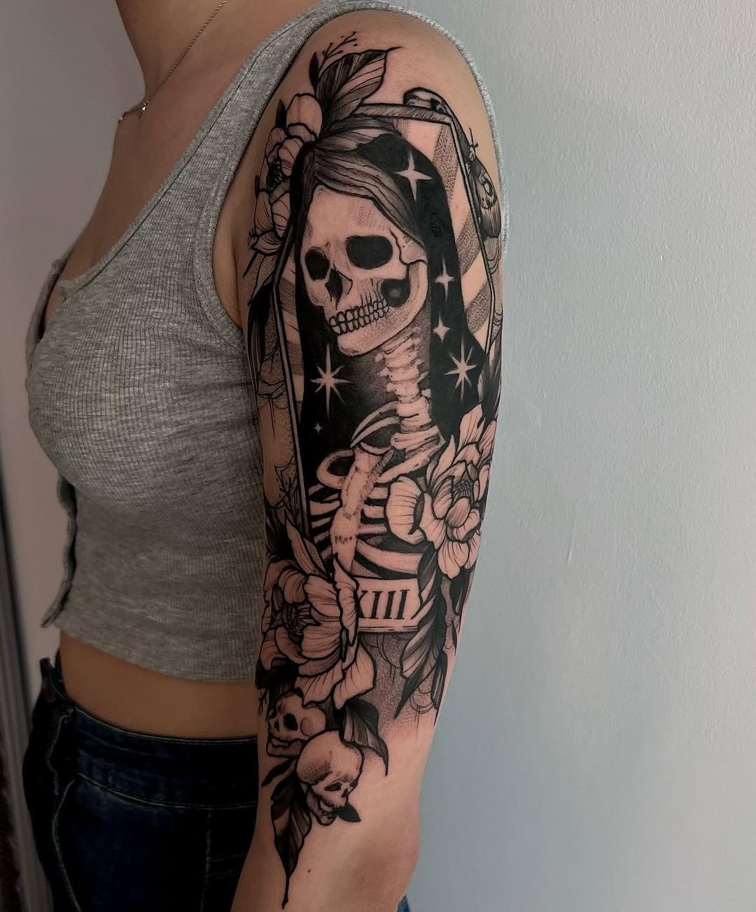 Bold Santa Muerte Tattoo with Floral Elements Tattoo Design