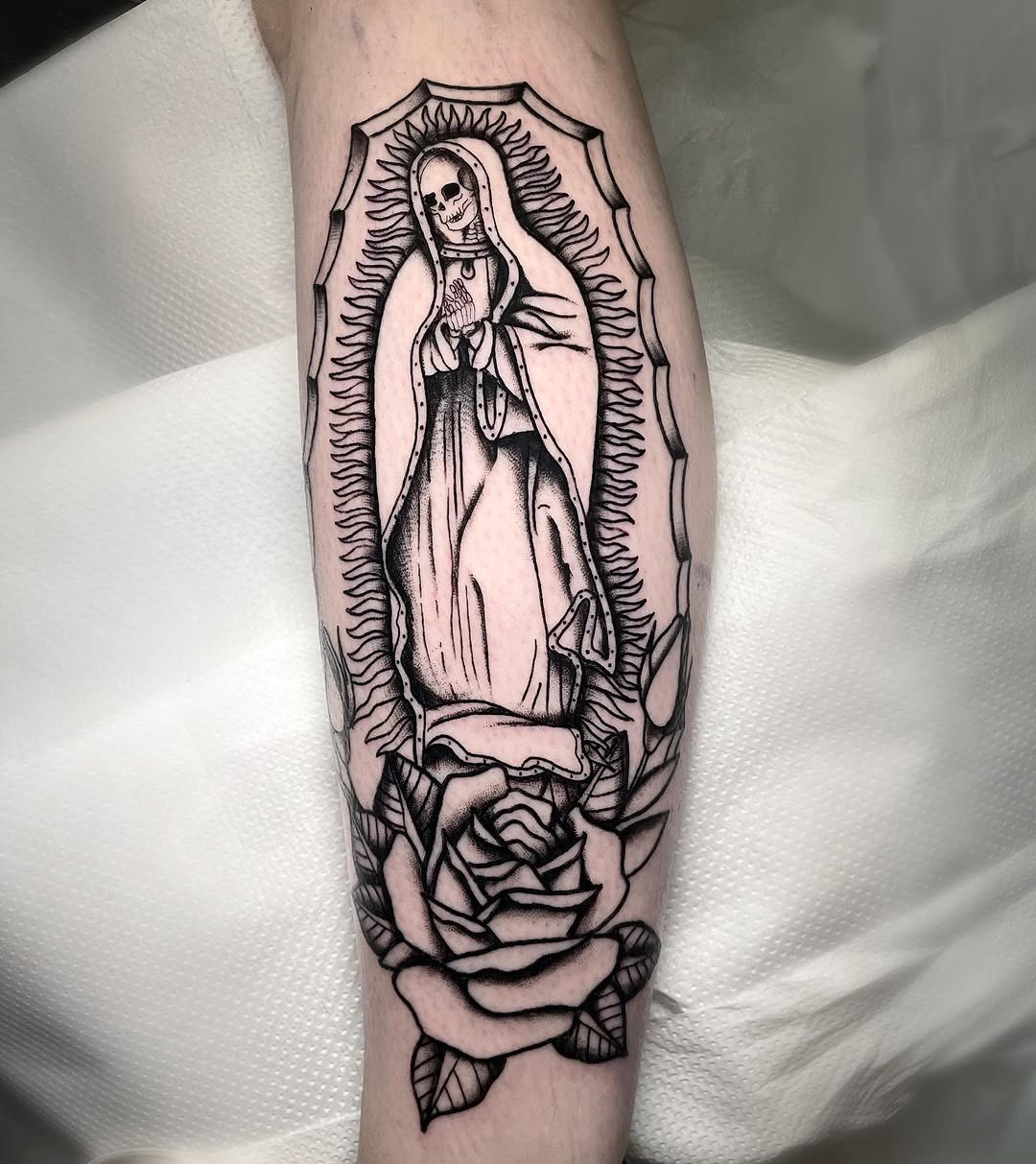 Elegant Santa Muerte tattoo with roses design Tattoo Design