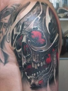 Awesome human skull tattoo on a man’s upper arm Tattoo Design