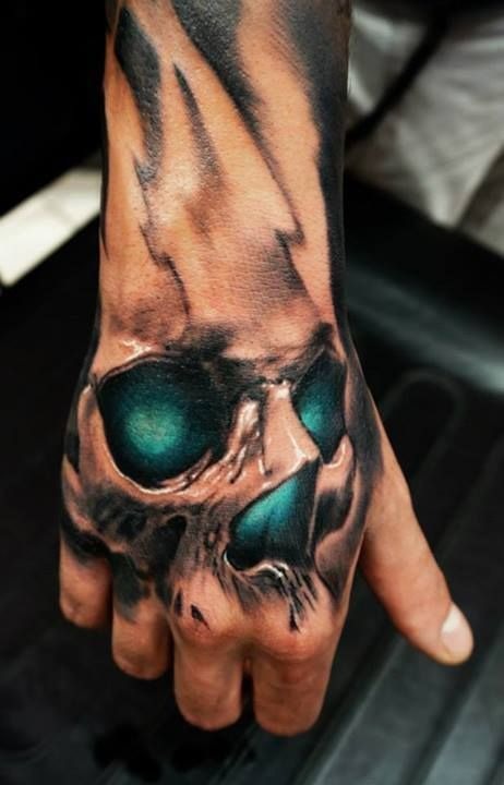 Hand tattoosidea: Awesome skull tattoo on a guy’s hand Tattoo Design