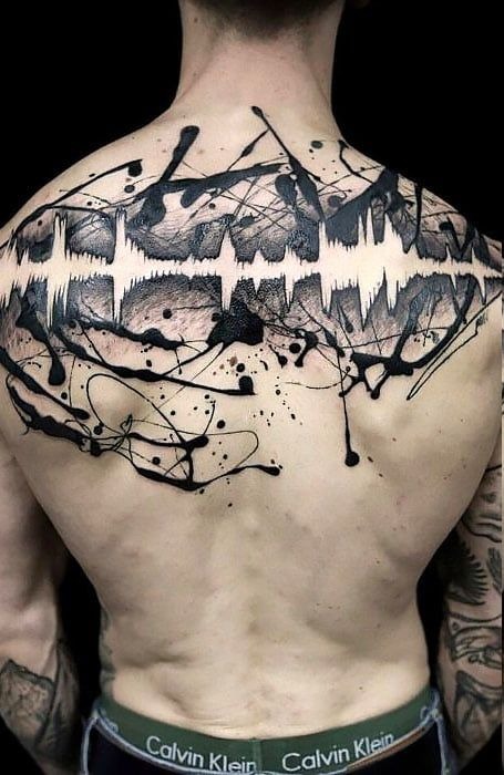 A soundwave transformed into a chaotic explosion of brushstrokes and ink splatters, this tattoo is nothing short of cool.
