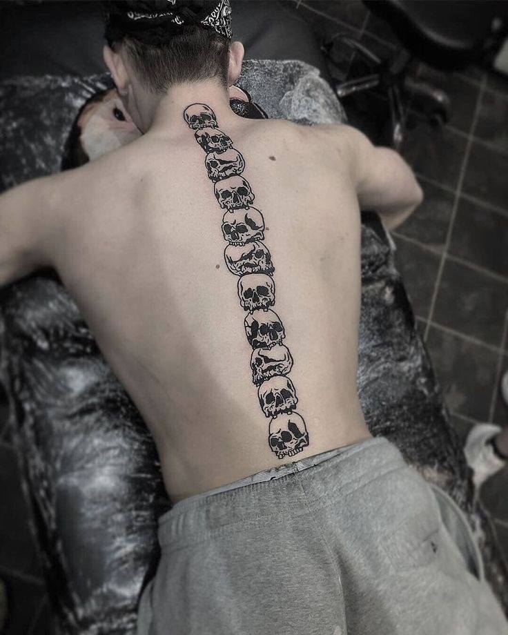 Bold and unapologetic, this design features a vertical stack of skulls running down the center of the back like vertebrae.