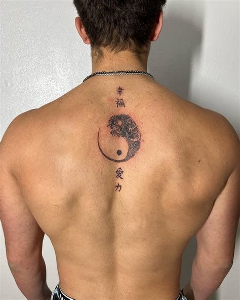 Centered along the spine is a bold red-and-black yin-yang symbol, half composed of a blossoming flower, paired with three vertical characters that speak to balance, love, and energy.