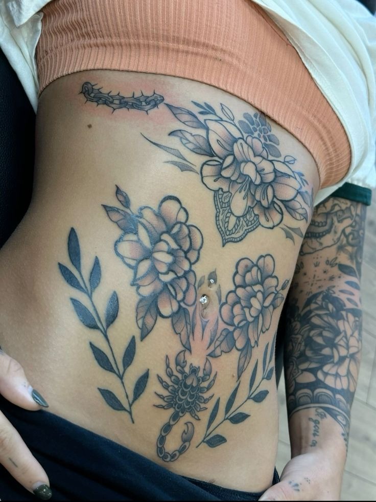 Floral and Scorpion Side-of-Stomach Collage Tattoo Design