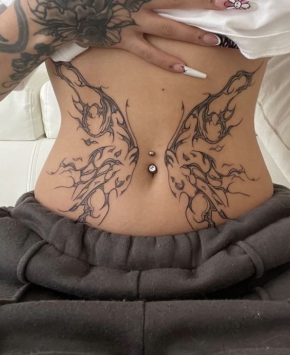 Symmetrical Flame Wings Lower Stomach Tattoo Design