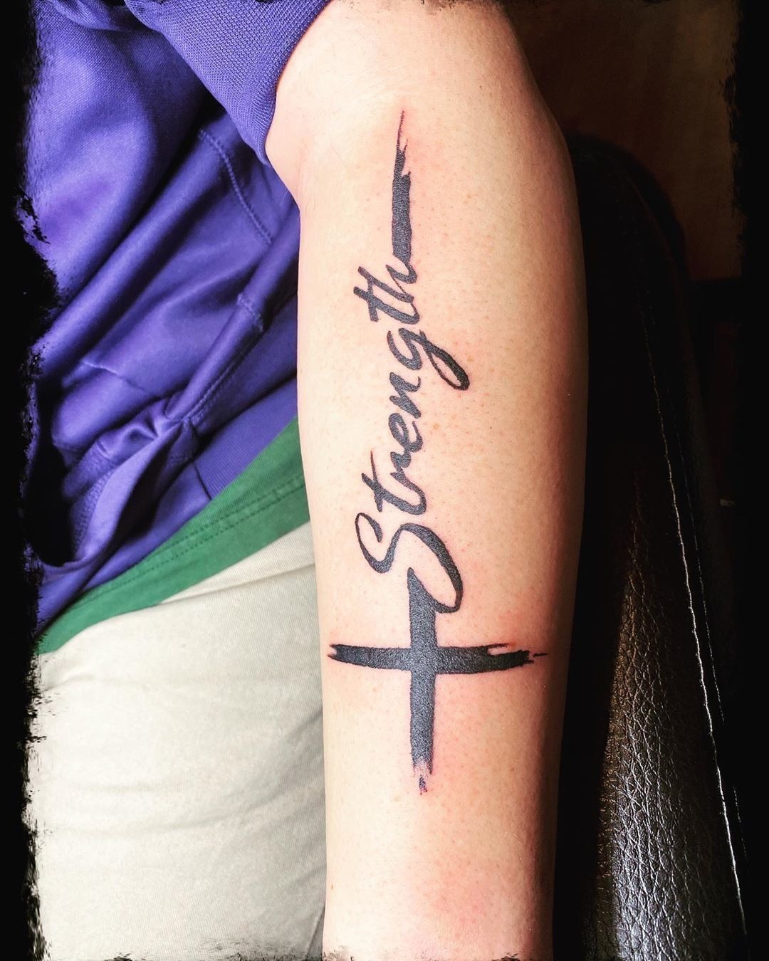Cross and Strength Forearm Tattoo, a tattoo design rendered in bold.