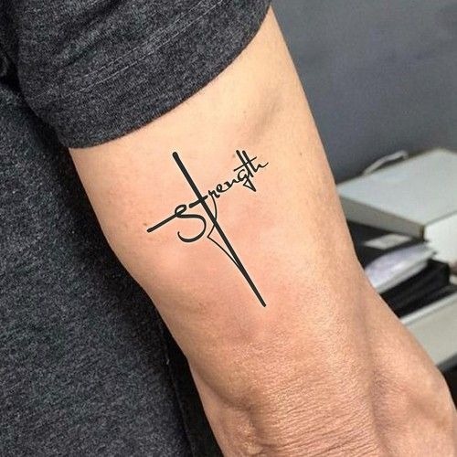 Minimalist Strength Cross Script, a tattoo design rendered in delicate fine-line.