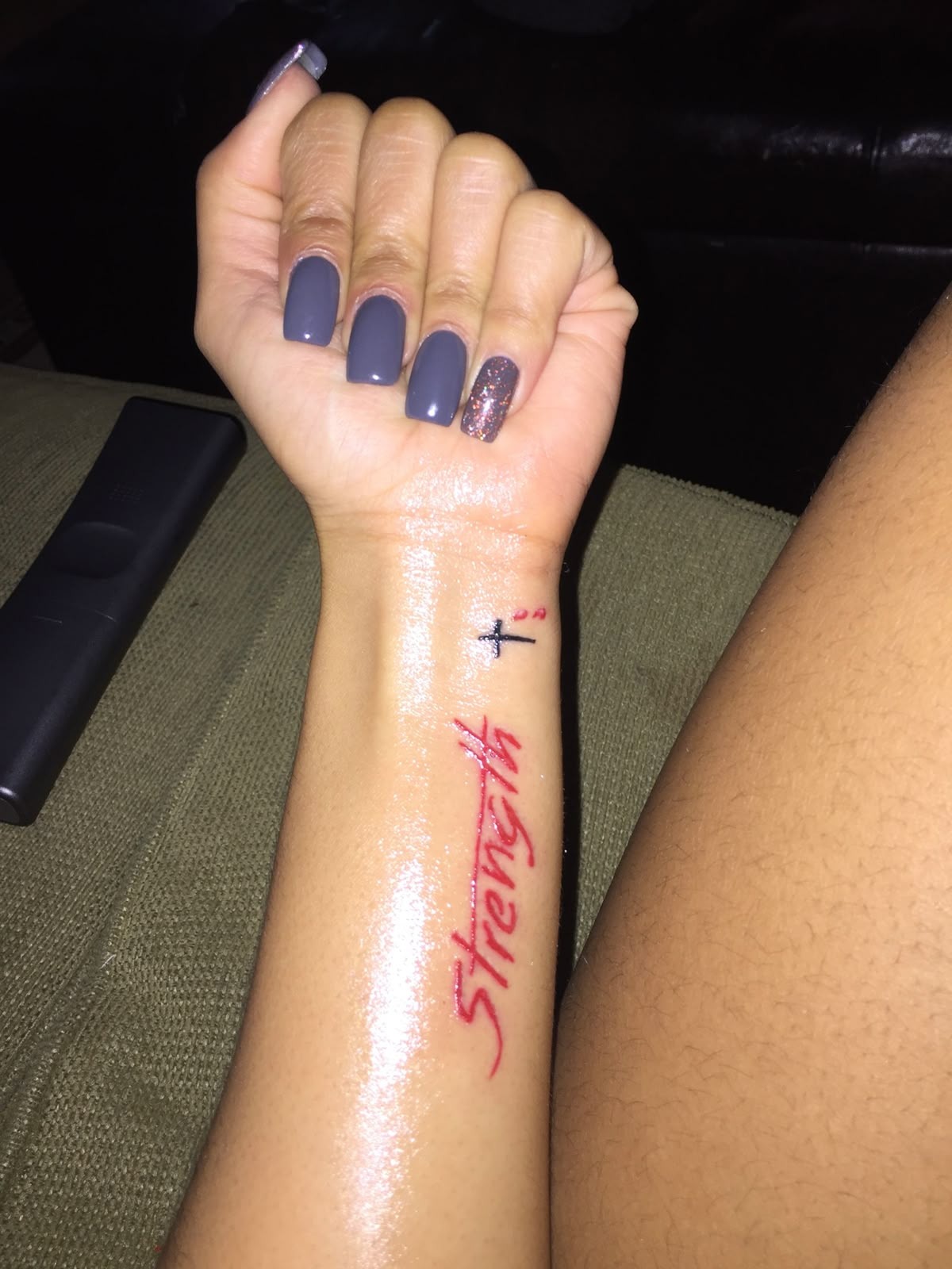 Red Ink Strength Wrist Tattoo, a tattoo design rendered in bold.