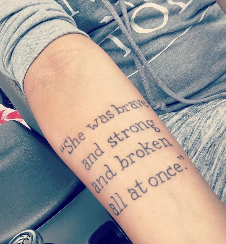 “She Was Brave and Strong” Quote Tattoo, a tattoo design rendered in clean detailed linework.