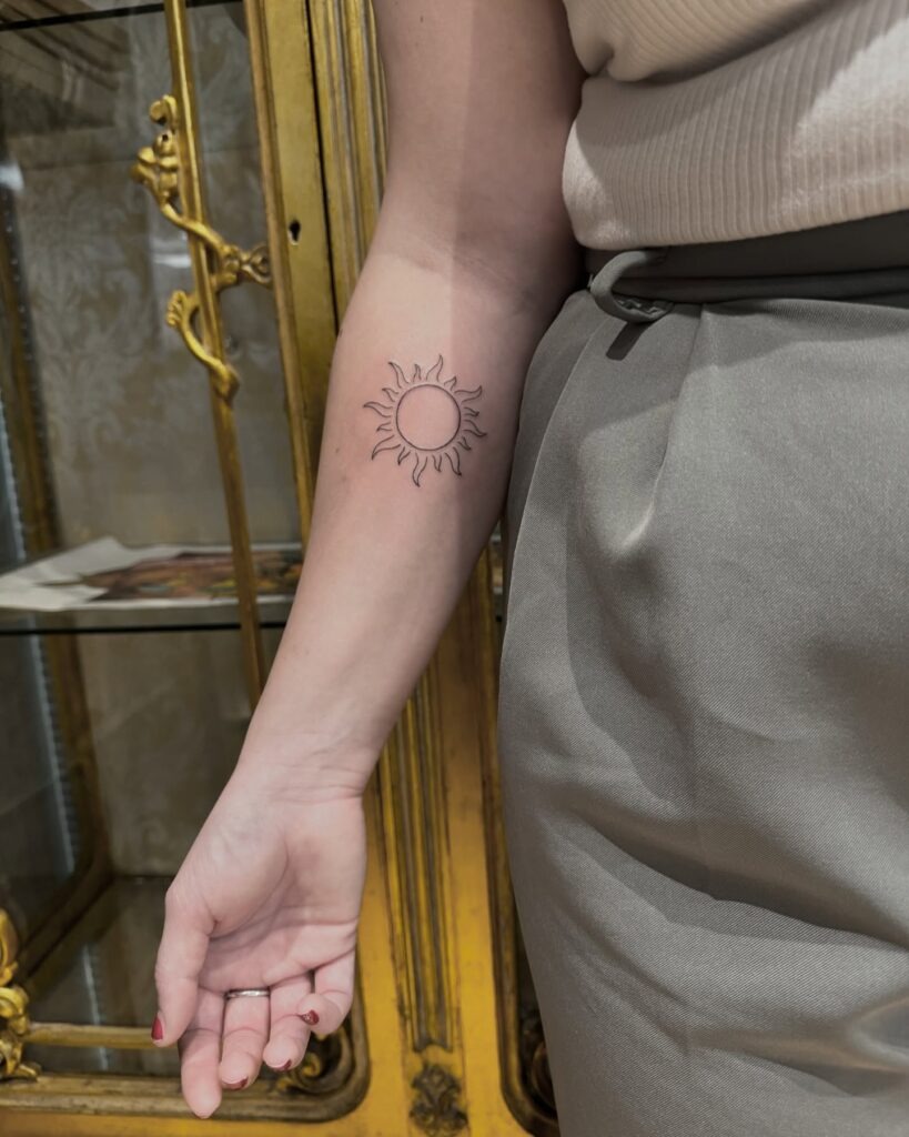 Clean Line Sun Tattoo on Inner Forearm Tattoo Design