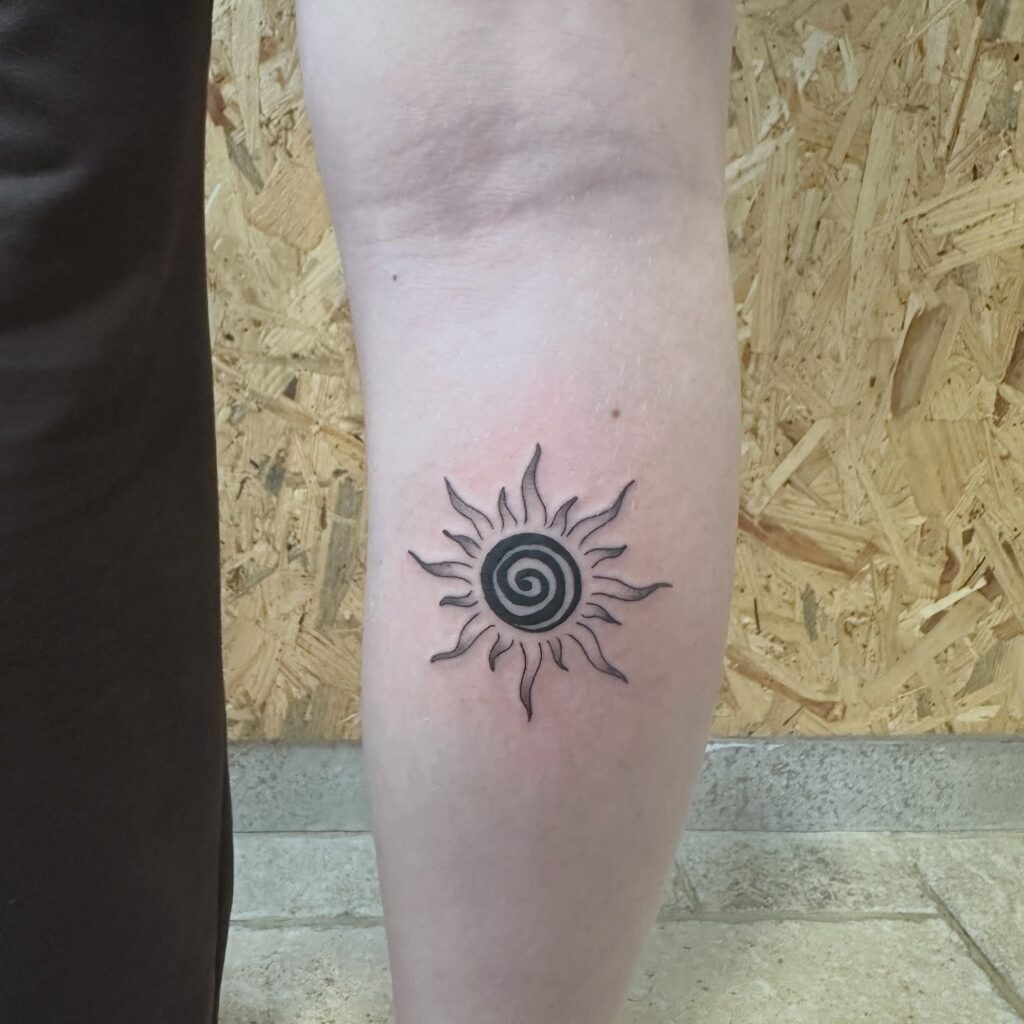 Spiral Core Sun Tattoo on Leg Tattoo Design