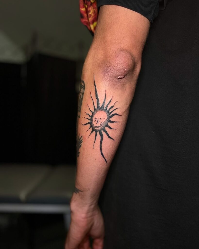 Sun with Skull Face Tattoo on Outer Forearm Tattoo Design