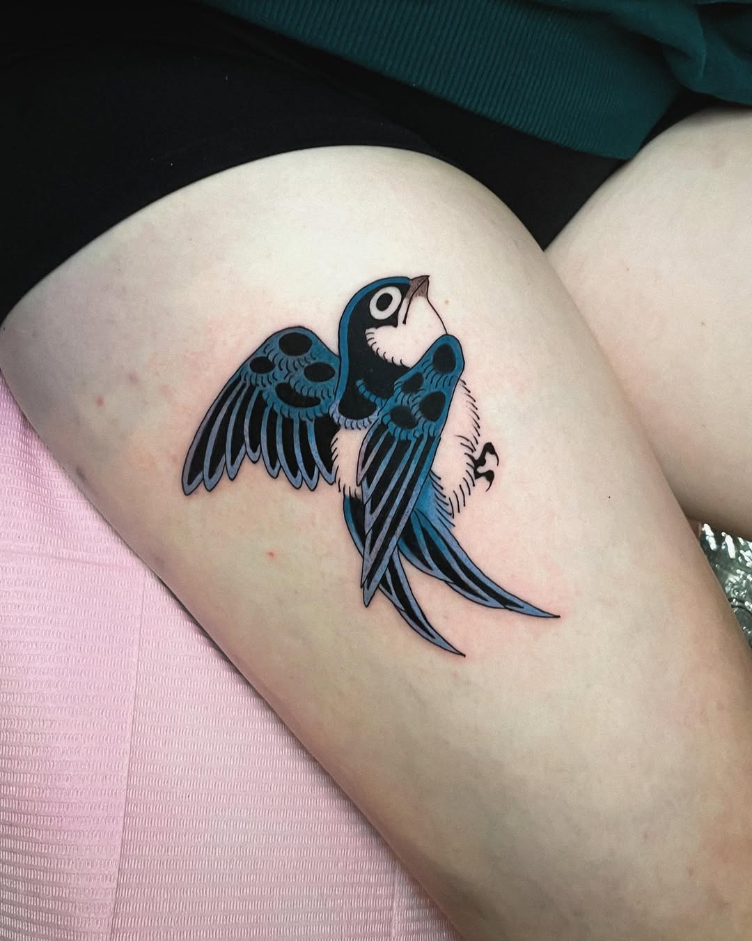 Bold blue swallow flying on thigh tattoo Tattoo Design