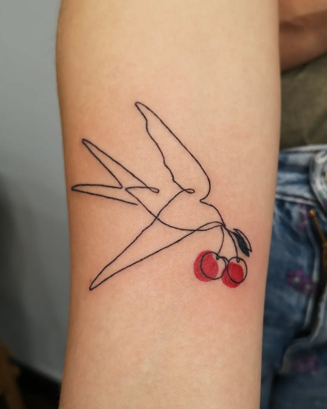 Charming swallow with cherry accents tattoo Tattoo Design