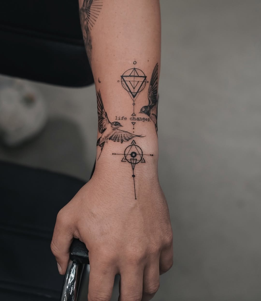 Elegant Swallow Tattoo with Symbolic Elements Tattoo Design