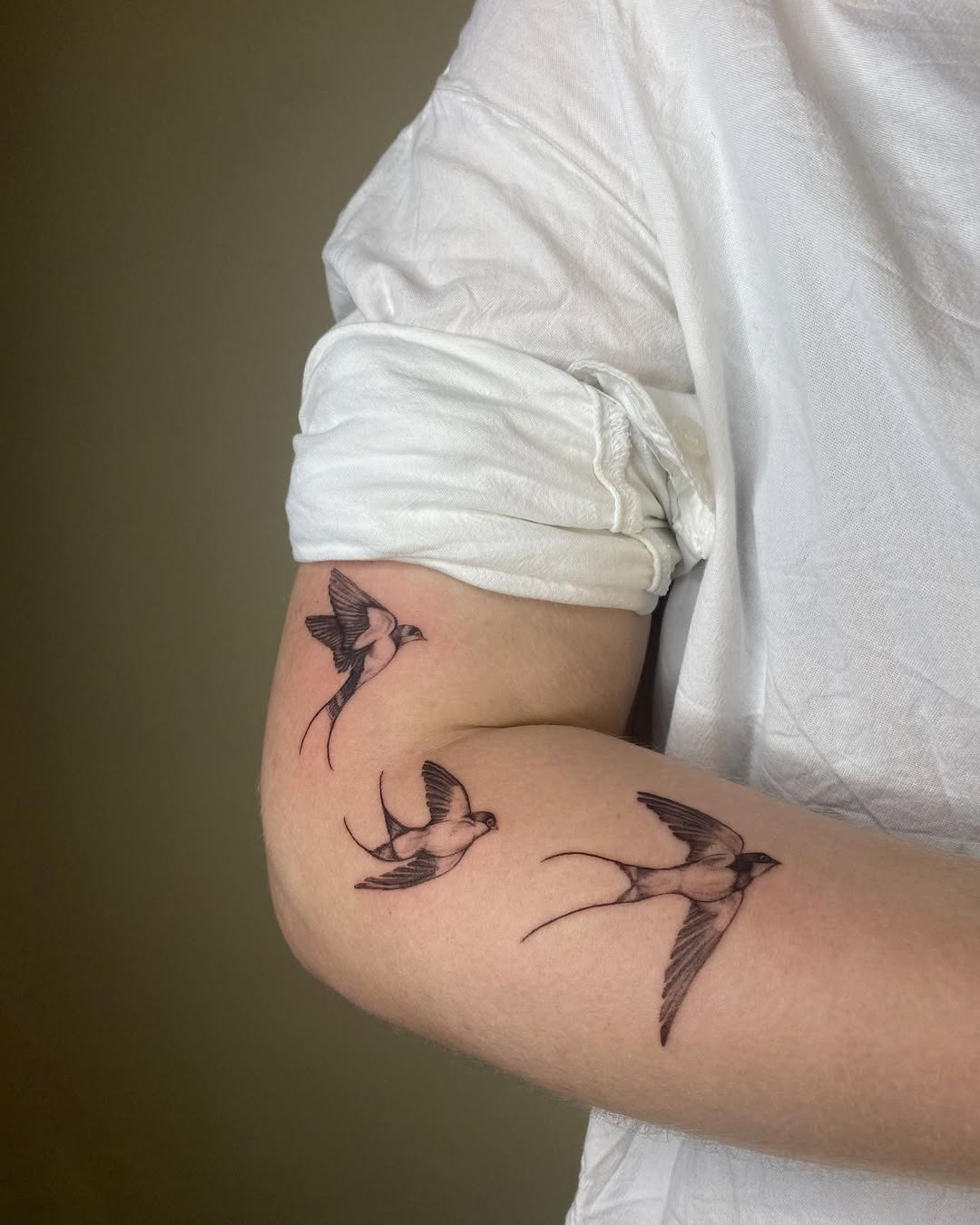 Elegant Swallow Tattoos on an Arm Tattoo Design