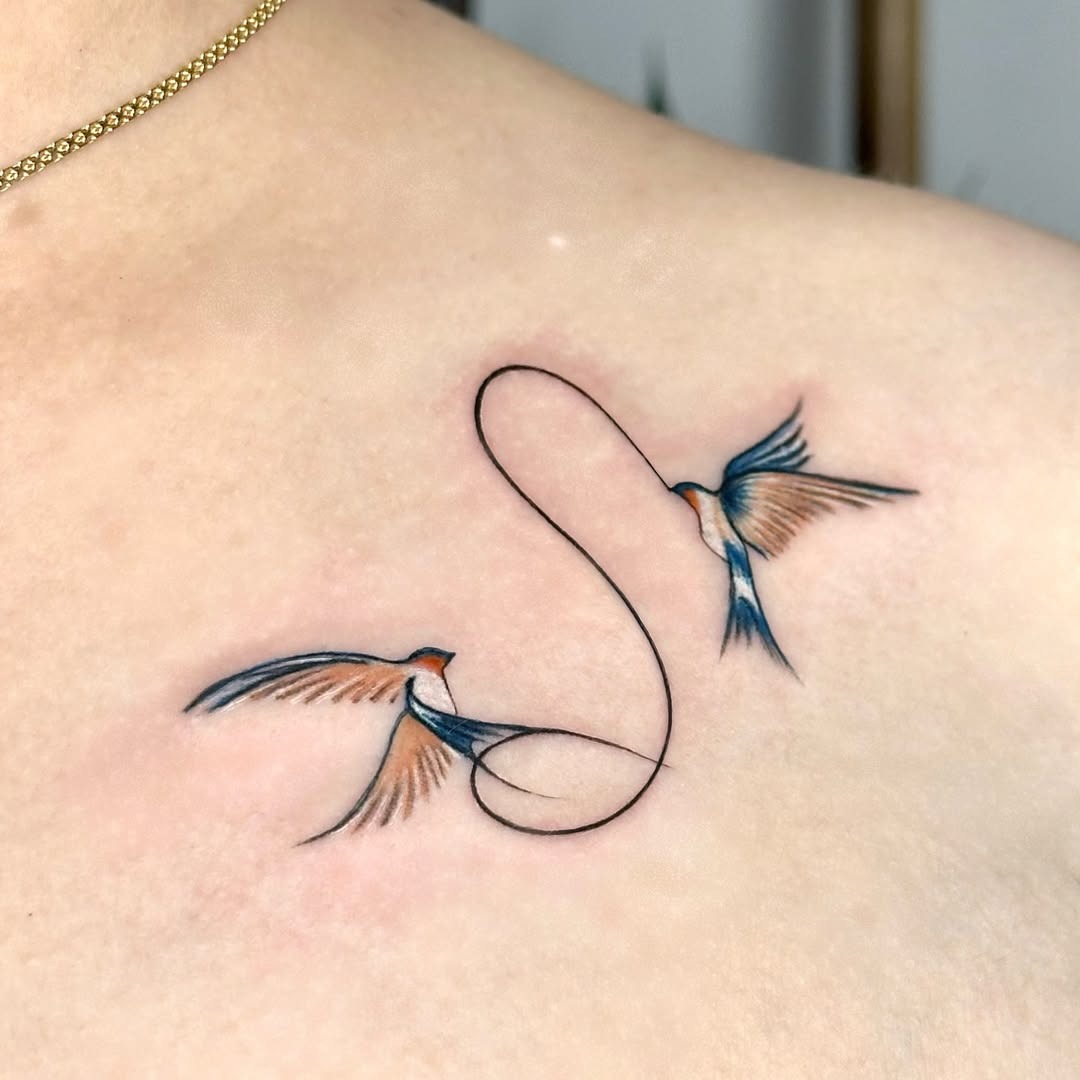 Elegant Swallows Symbolizing Love and Freedom Tattoo Design