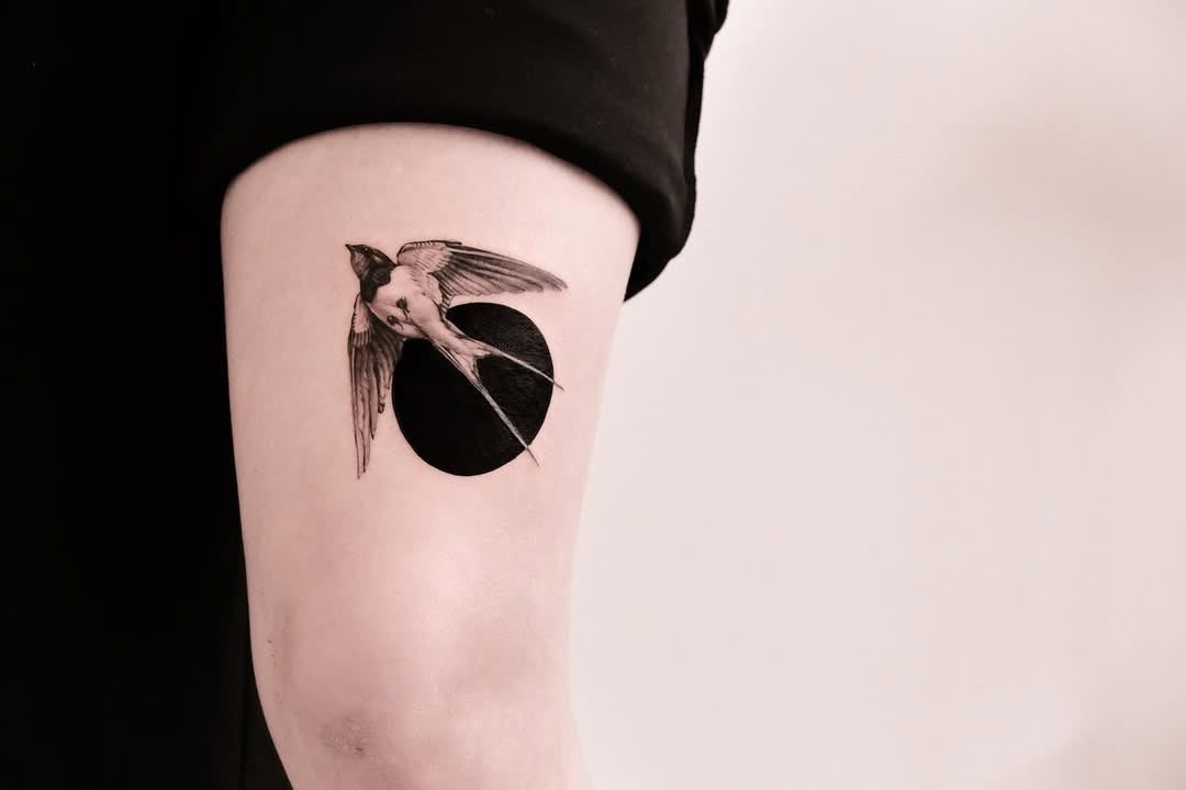 Stunning swallow tattoo against a dark backdrop Tattoo Design