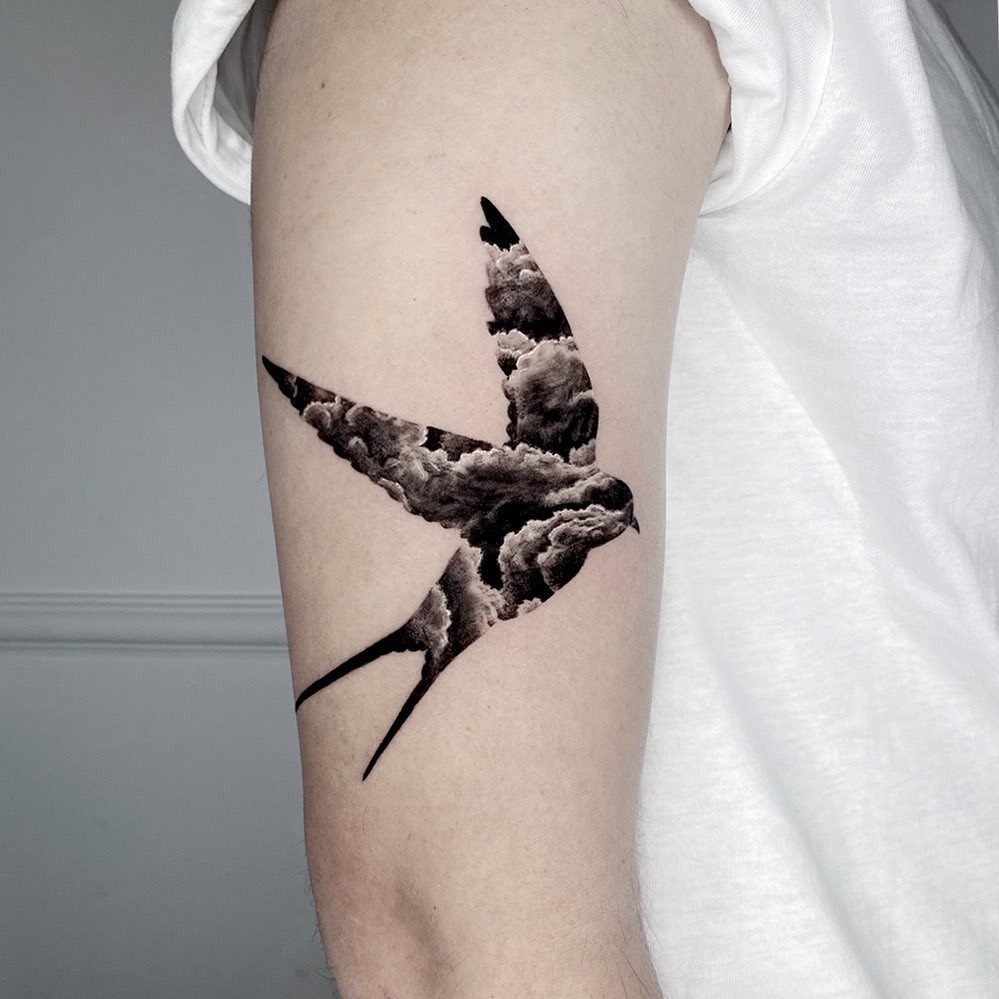 Stunning swallow tattoo with cloud design Tattoo Design