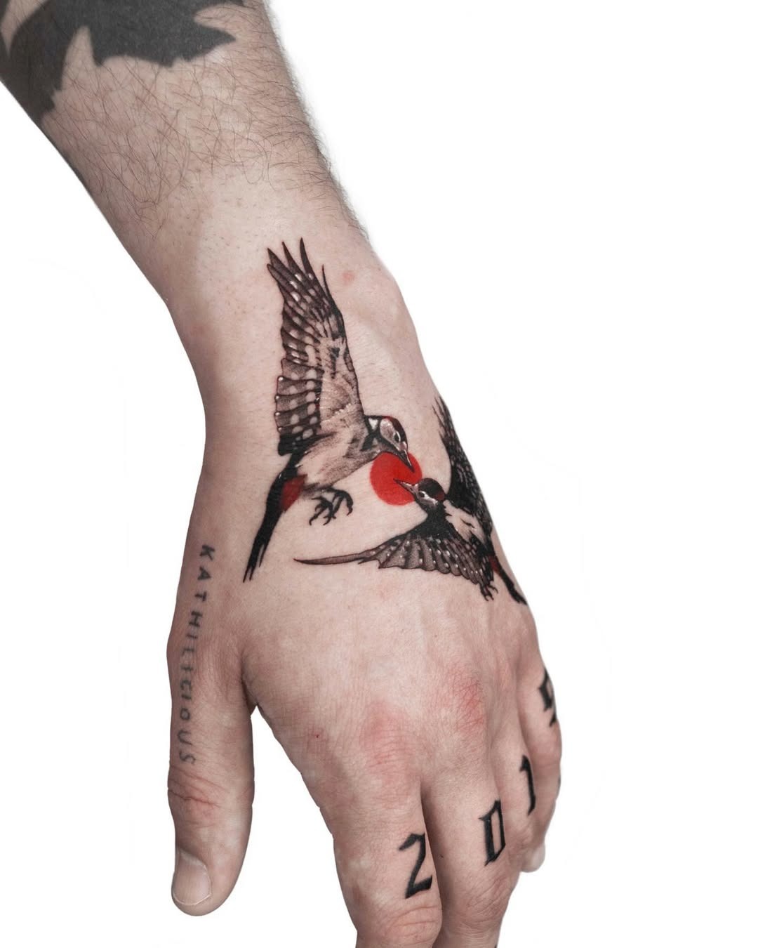 Vivid swallow tattoos take flight on hand. Tattoo Design