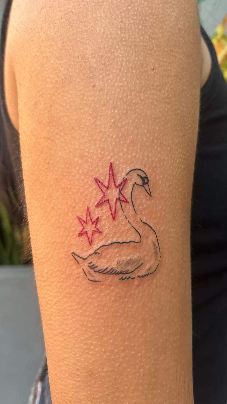 Tiny Swan With Red Star Accents Tattoo Design