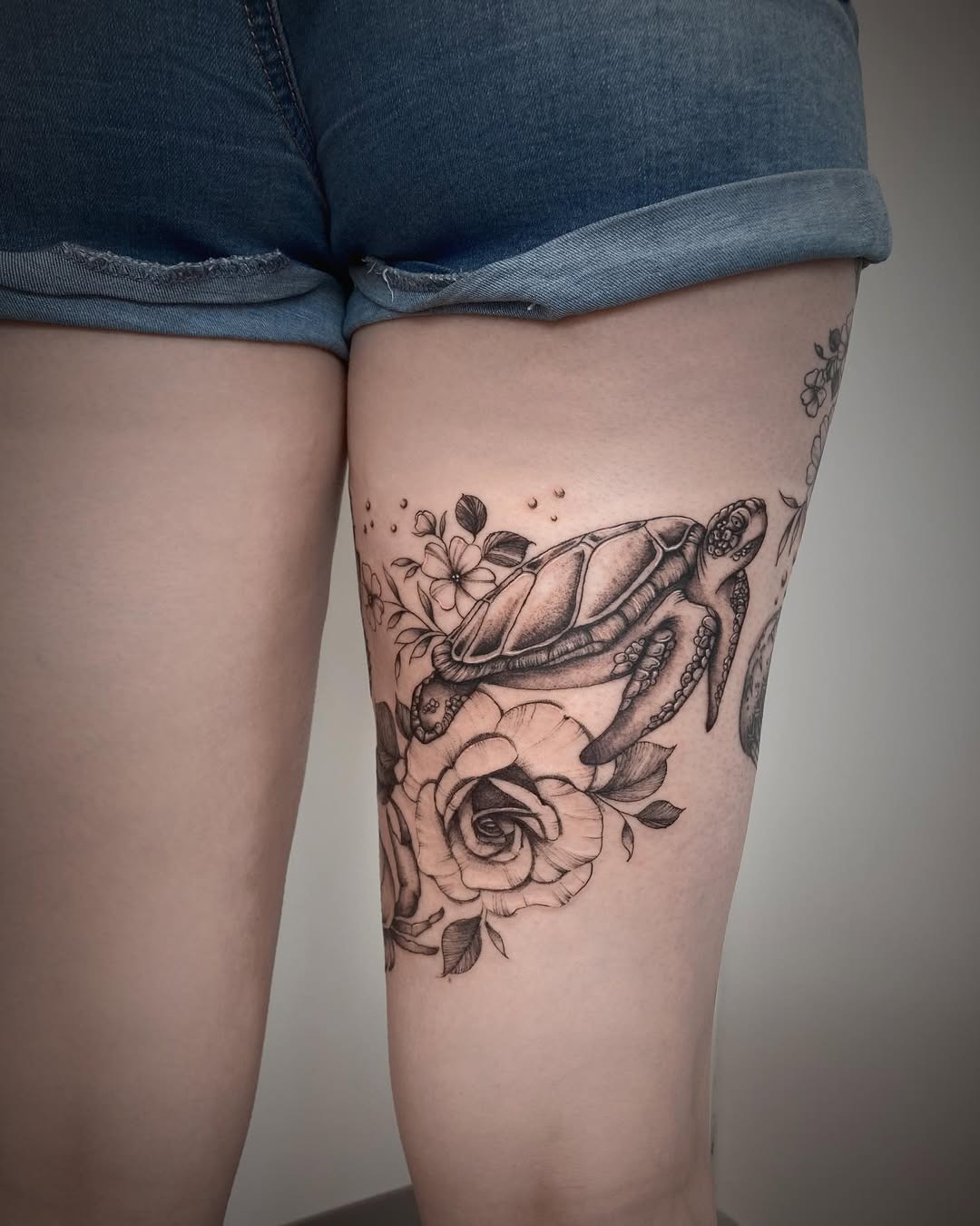 Beautiful turtle tattoo embellished with flowers Tattoo Design