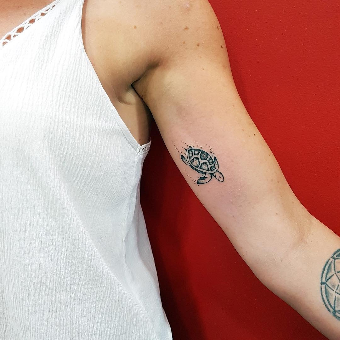 Charming minimalist turtle tattoo on arm Tattoo Design