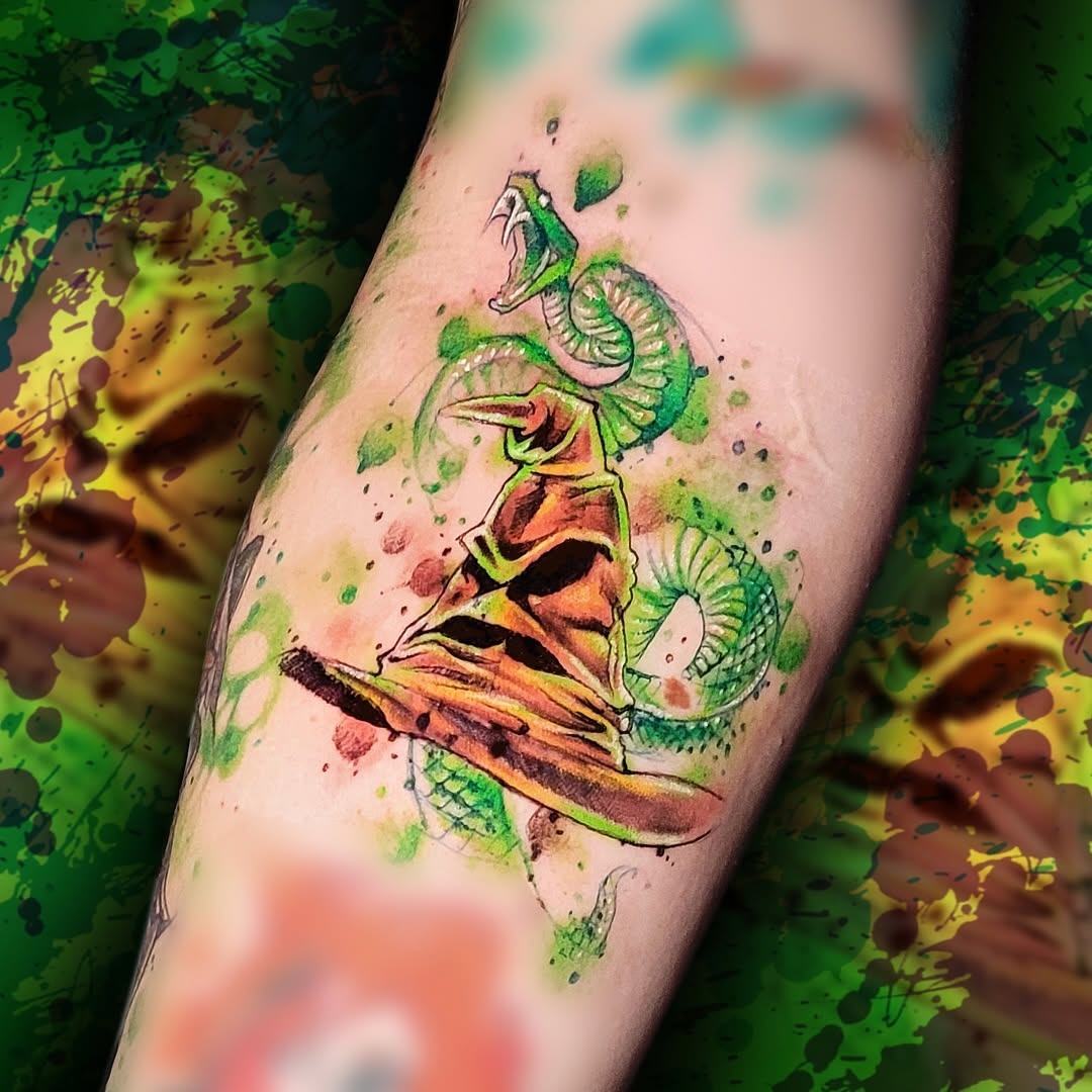 Bold watercolor snake and hat tattoo design Tattoo Design