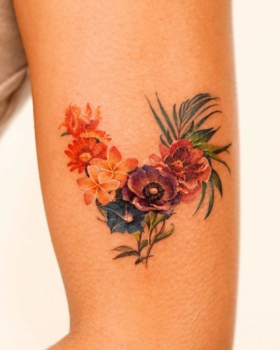 Colorful floral watercolor tattoo on arm Tattoo Design