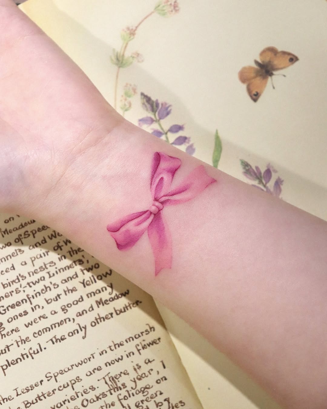 Delicate pink ribbon tattoo on pale skin Tattoo Design