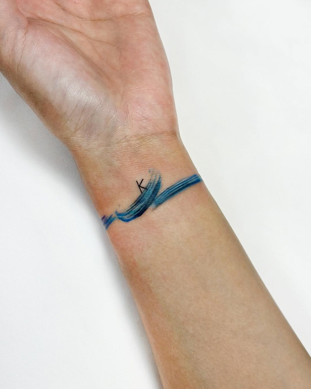 Minimalist watercolor tattoo on the wrist Tattoo Design
