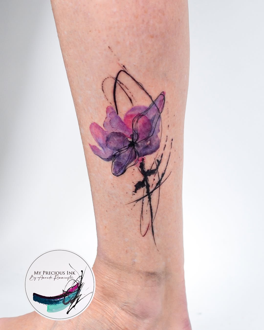 Vibrant floral watercolor tattoo on ankle Tattoo Design
