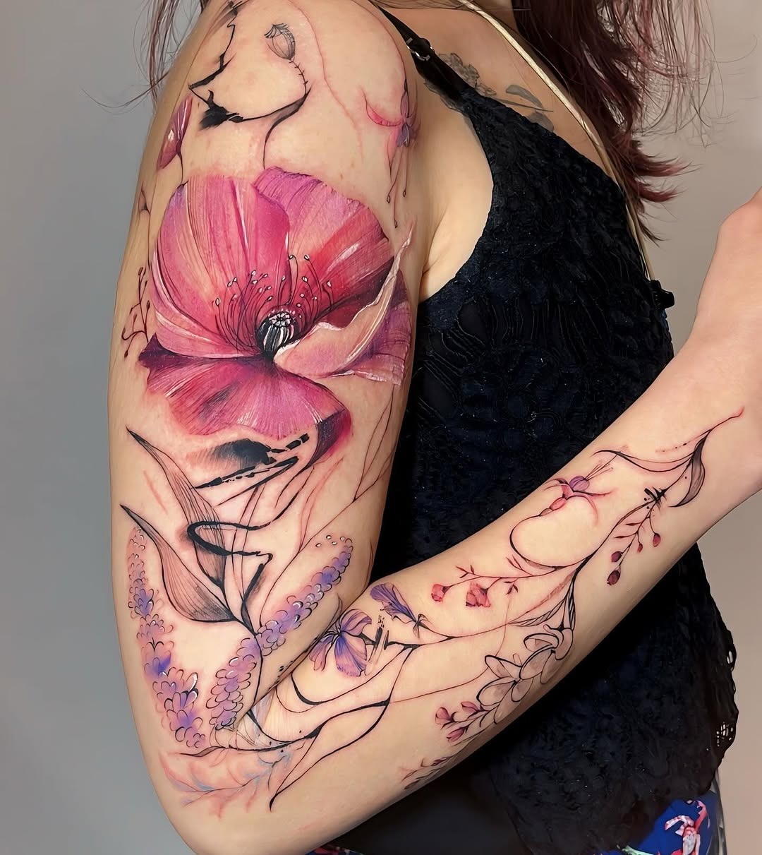 Vibrant floral watercolor tattoo on arm Tattoo Design