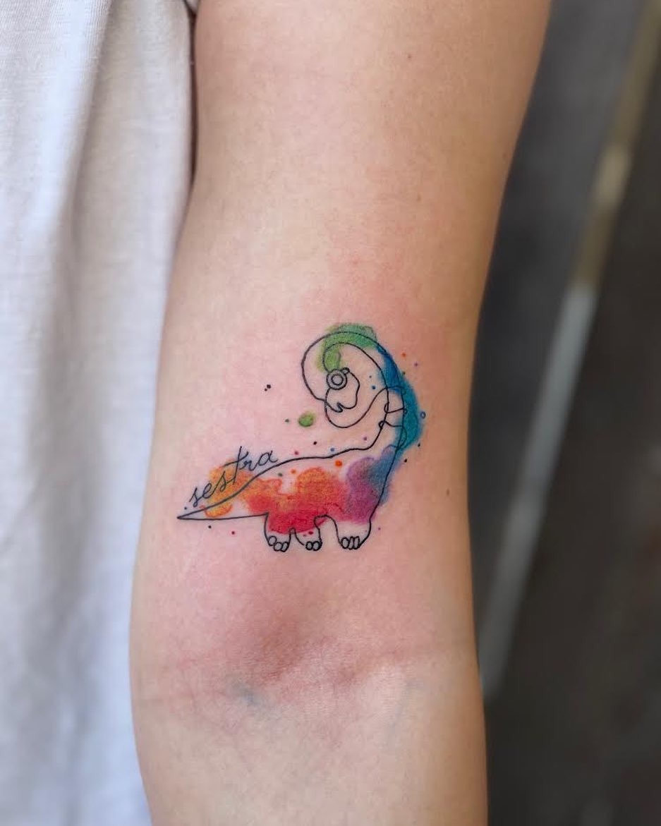 Vibrant watercolor dinosaur tattoo with flowing colors Tattoo Design