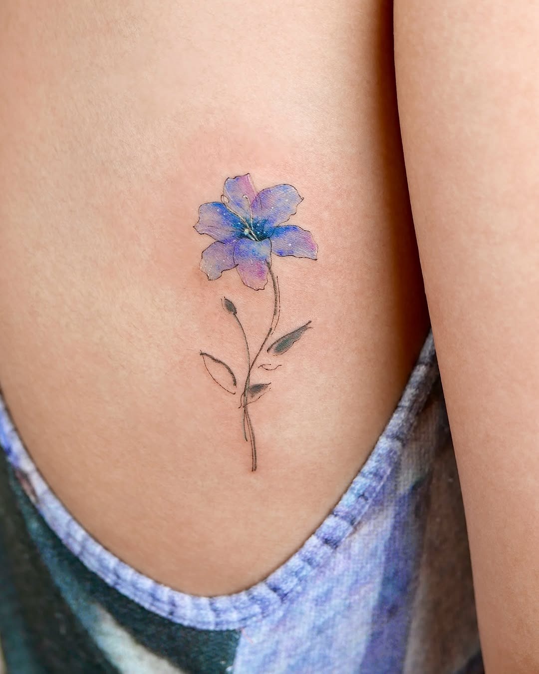 Vibrant watercolor flower tattoo on the arm Tattoo Design
